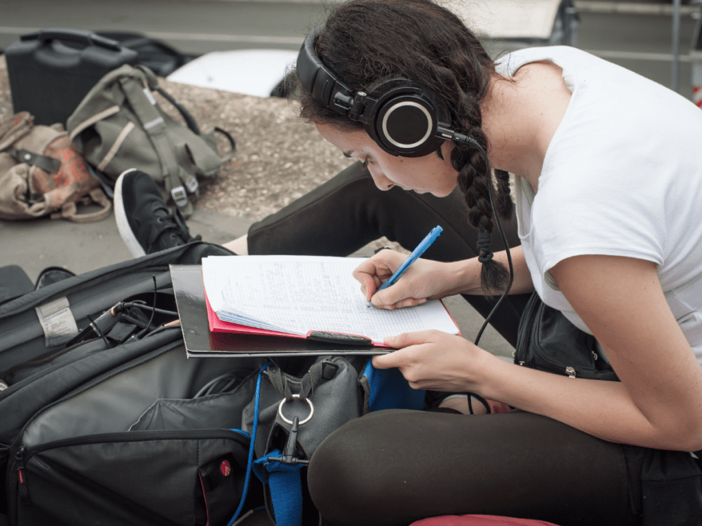 Script supervisor reviewing notes on set.